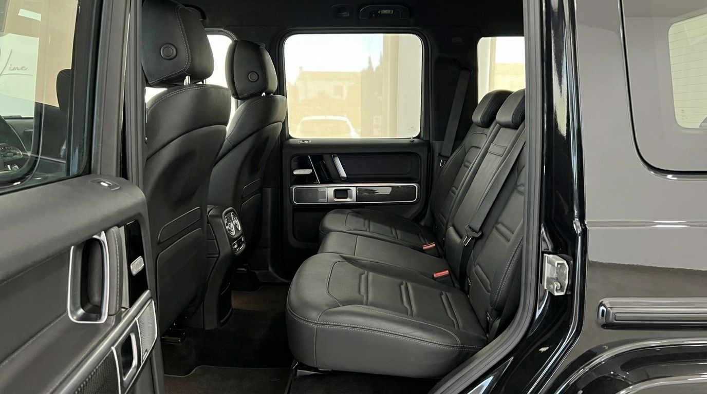 The luxurious black leather rear seats and door panel of the Mercedes-Benz AMG G 63 in Alicante are visible.