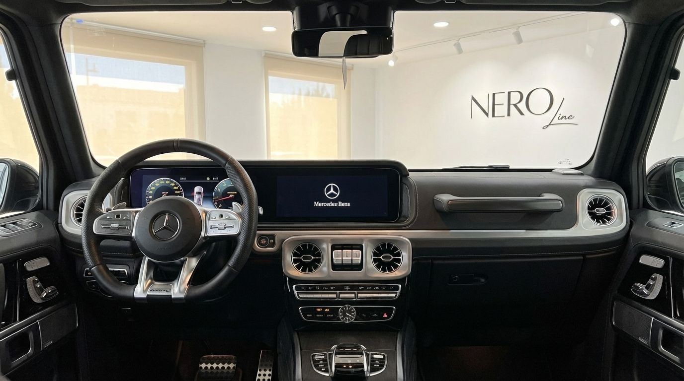 The luxurious interior of the Mercedes-Benz AMG G 63 in Alicante, featuring its advanced dashboard, steering wheel, and central display.