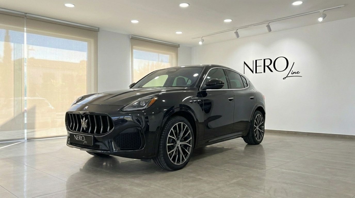 The sleek gloss black 2024 Maserati Grecale is showcased in a front three-quarter view within a modern showroom in Marbella.