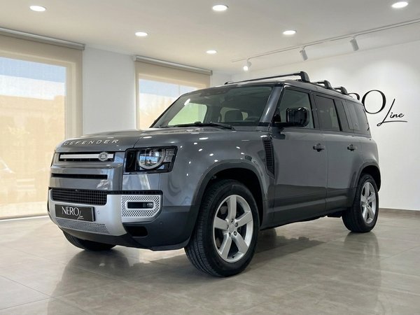 Land Rover Defender 3.0 — Front view in Marbella The 2022 gloss dark grey metallic Land Rover Defender 3.0 is showcased from a front three-quarter view in a Marbella showroom.
