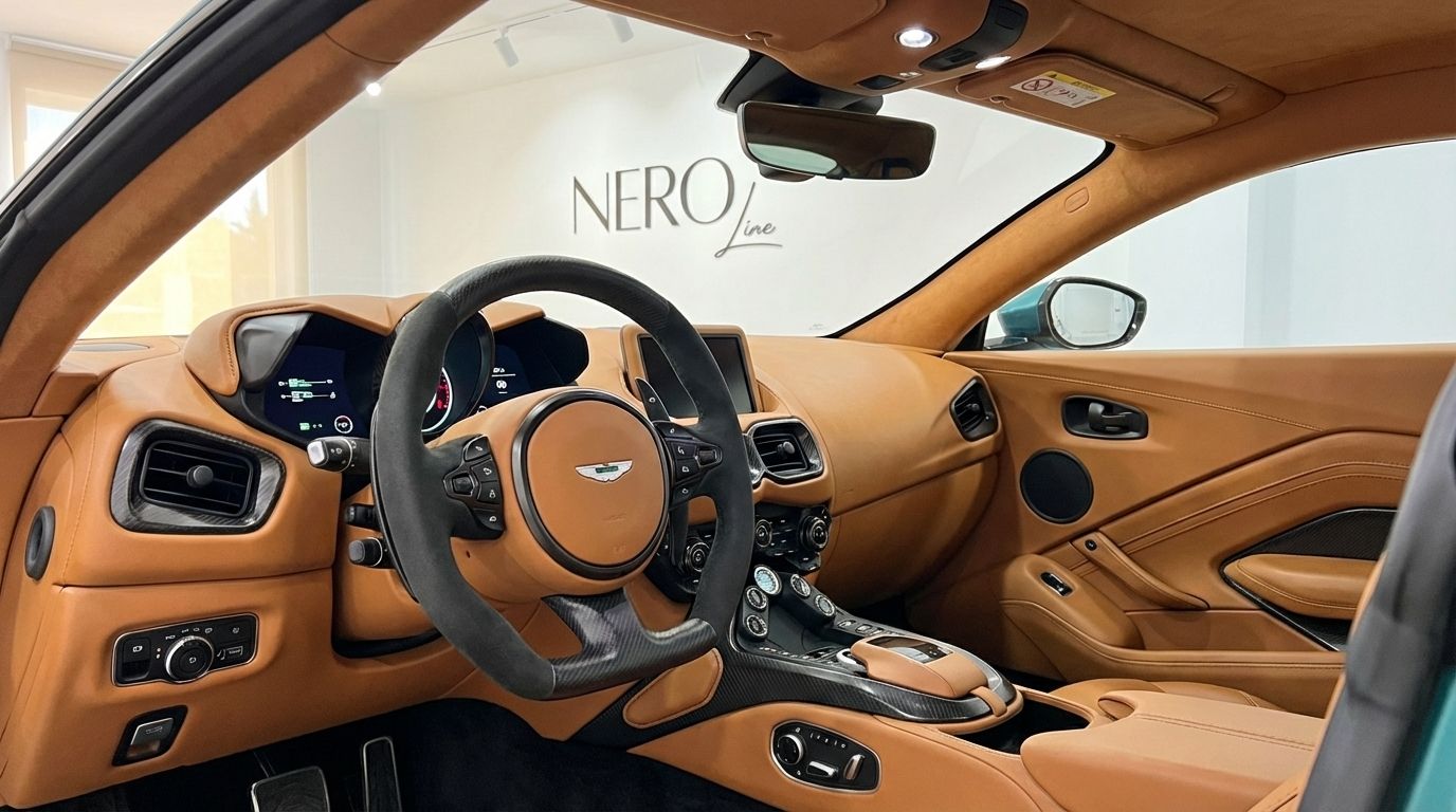 The luxurious tan leather interior and steering wheel of the Aston Martin Vantage F1 Spec in Alicante are prominently displayed.