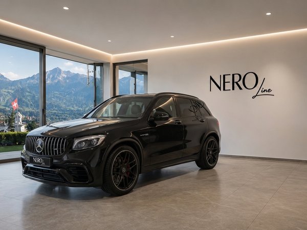 Mercedes-Benz GLC 63 AMG — Showroom in Zurich A black Mercedes-Benz GLC 63 AMG SUV is parked in a modern showroom with a stunning mountain view of Zurich.