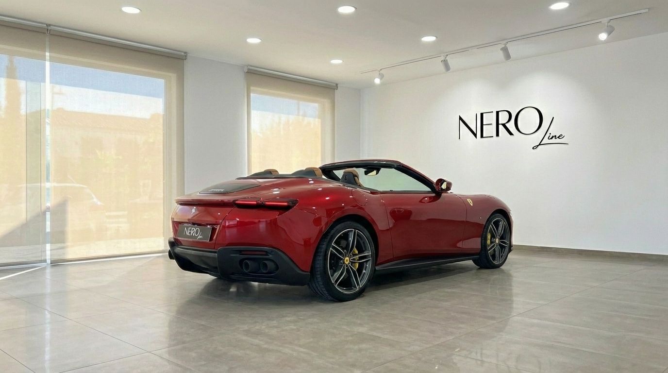 The red 2023 Ferrari Roma Spider, with its convertible top down, is parked in a showroom in Barcelona.