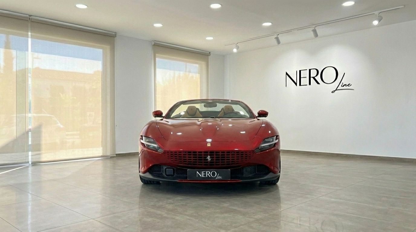 The racing red 2023 Ferrari Roma Spider is showcased in a bright studio setting in Barcelona, featuring its elegant front design.