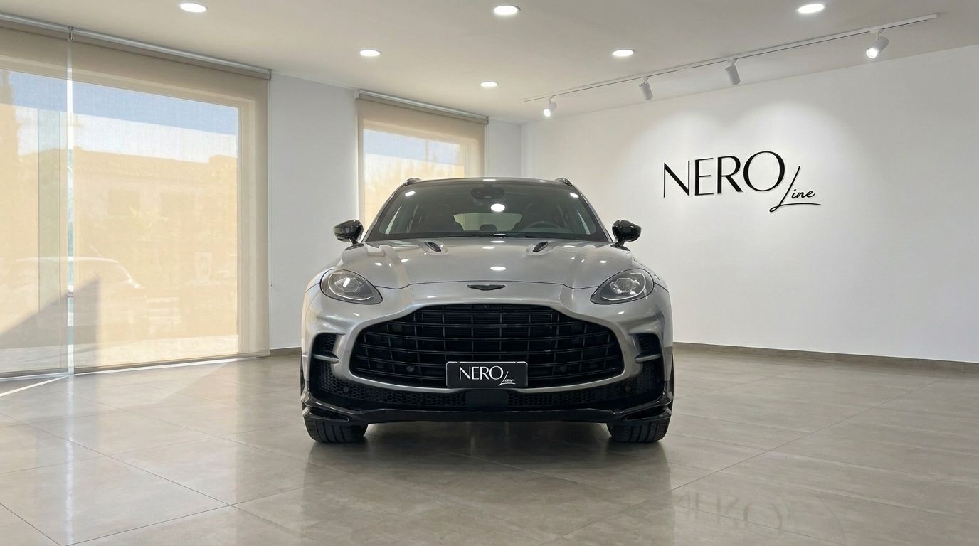 The Aston Martin DBX707 in metallic silver is shown from the front, parked in a modern showroom in Madrid.