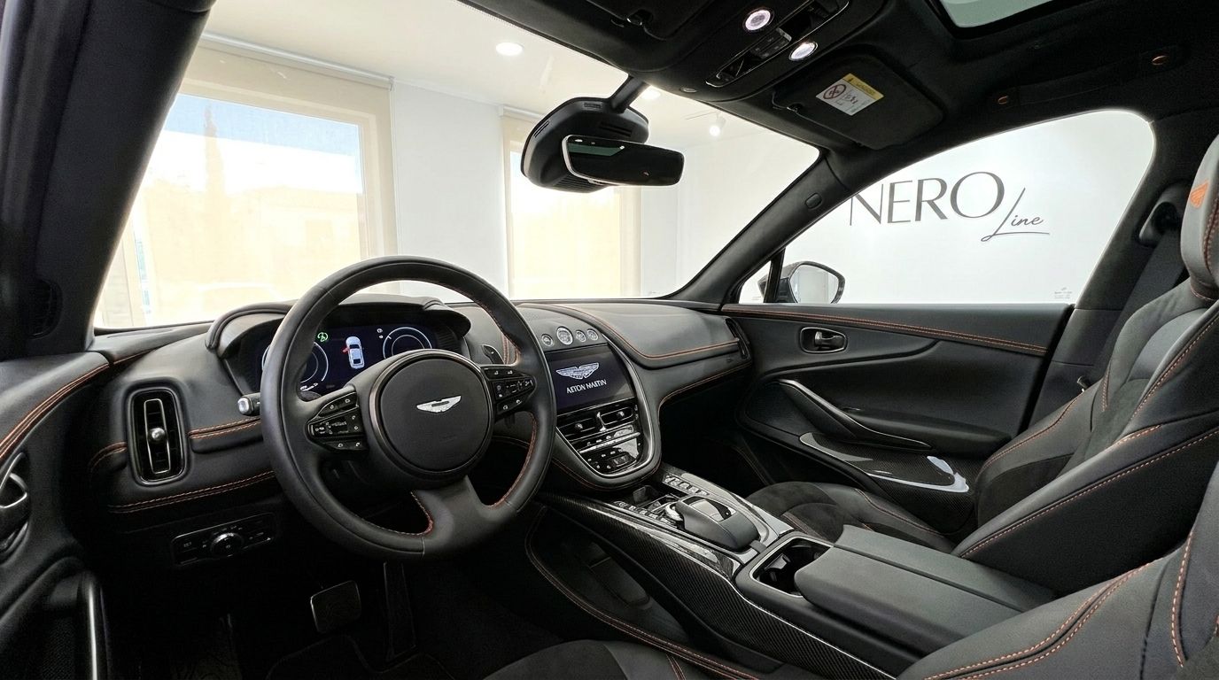 The luxurious interior of the 2024 Aston Martin DBX707 in Metallic Silver, showcasing the dashboard and steering wheel in Madrid.