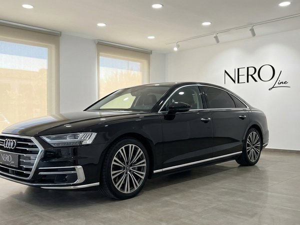 Audi A8 L — Luxury Sedan in Alicante Showroom The black 2021 Audi A8 L luxury sedan is showcased from a front three-quarter view in a showroom in Alicante.
