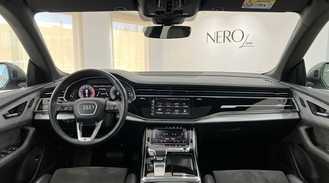The luxurious interior of the Audi Q8 TDI in Alicante, featuring its advanced dashboard, steering wheel, and dual touchscreens.