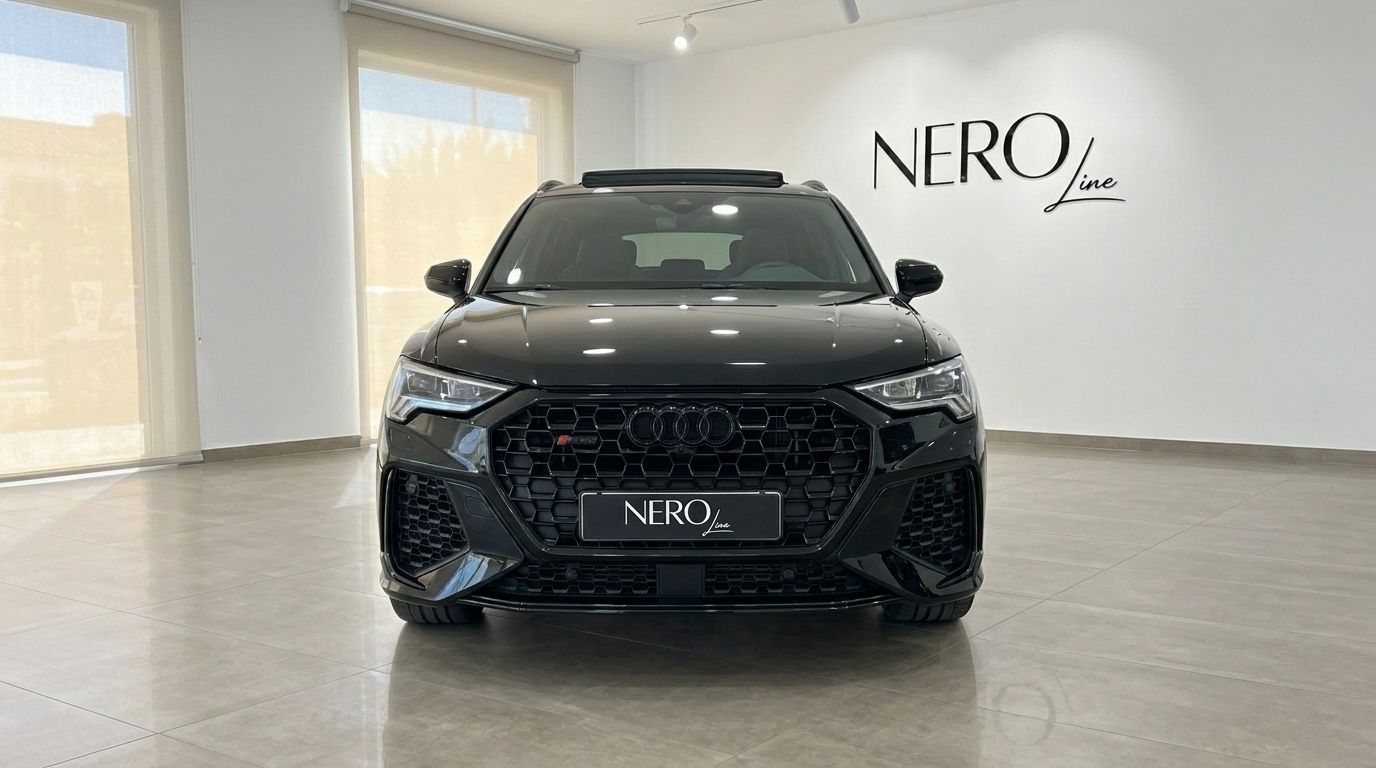 The black Audi RS Q3 is shown from a head-on front view in a bright showroom in Alicante, highlighting its powerful design.