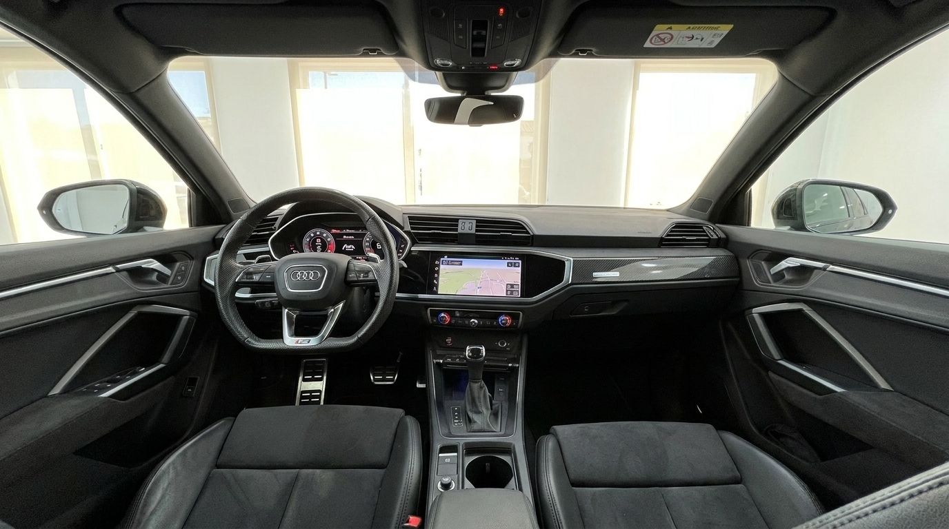 The interior of the 2022 Audi RS Q3 in Alicante, showcasing the dashboard, steering wheel, and front seats.