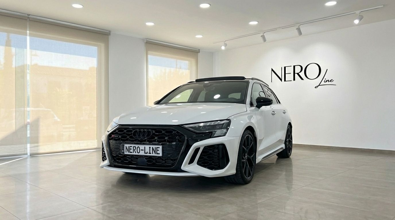 The Pearl White 2025 Audi RS3 is showcased from a front three-quarter angle in a bright showroom in Marbella.