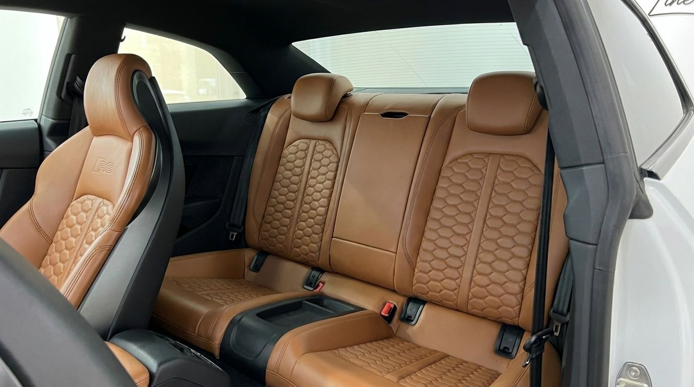 The luxurious brown leather rear seats with honeycomb stitching inside the Audi RS5, available in Alicante.