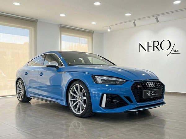 Audi RS5 — Front three-quarter view Alicante Blue 2020 Audi RS5 luxury car, shown from the front three-quarter angle in a showroom in Alicante.