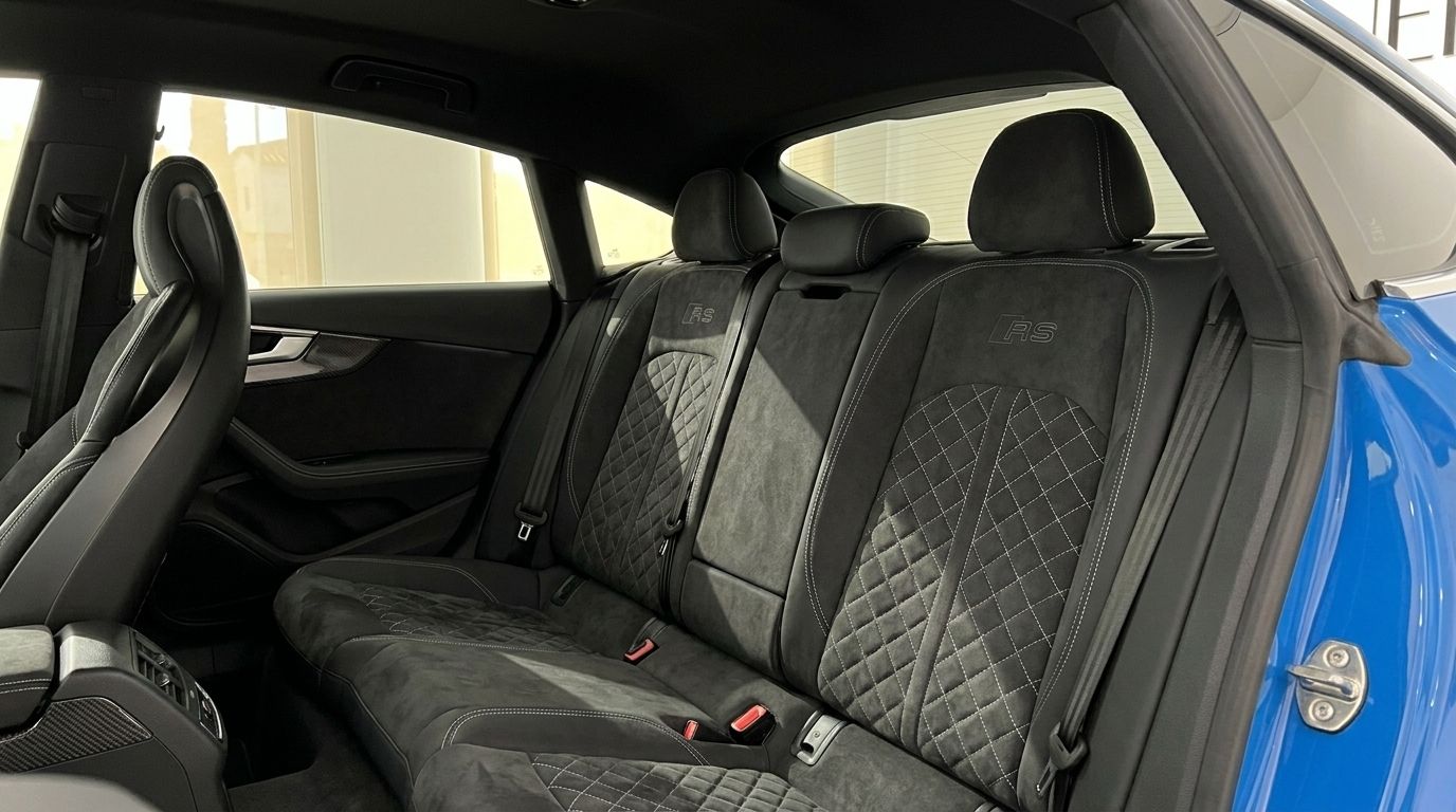 The luxurious black quilted rear seats with RS logo of the 2020 Audi RS5, viewed from the front in Alicante.