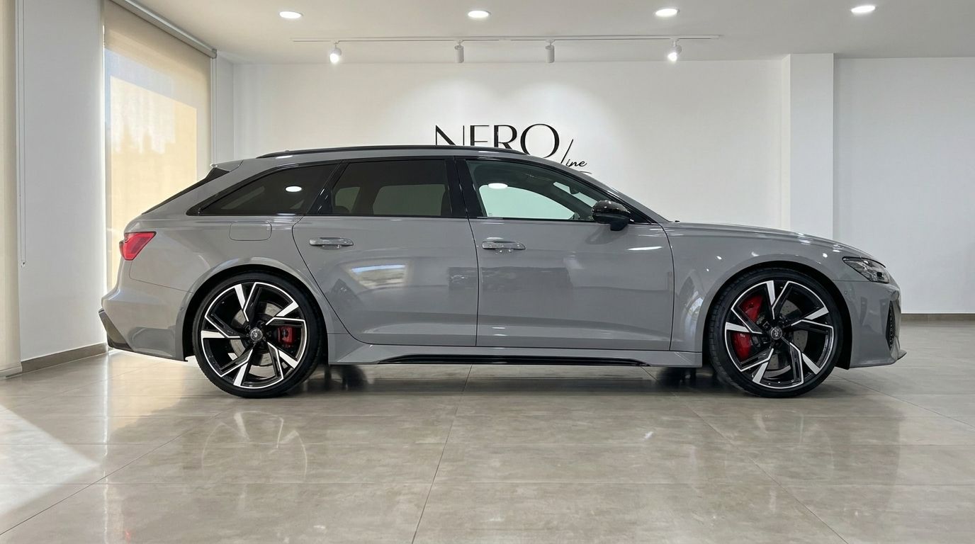 The gloss Nardo Grey Audi RS6 Avant is displayed in a showroom, highlighting its sleek side profile and distinctive wheels in Ibiza.