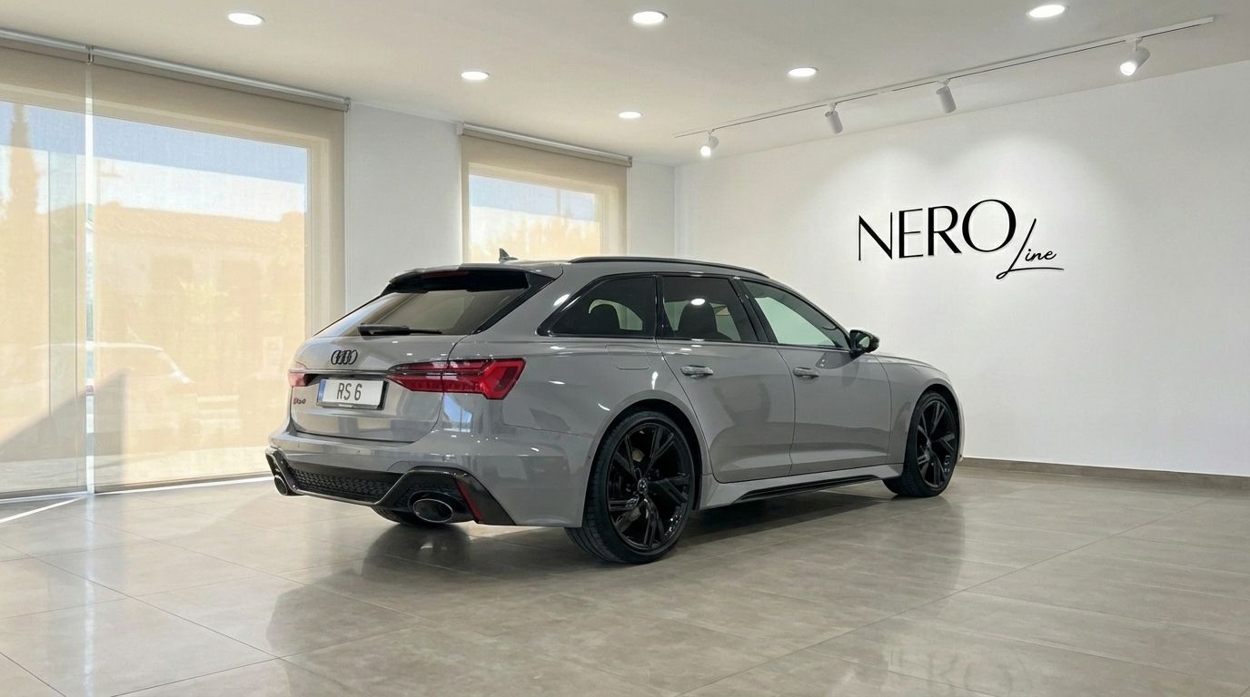 The metallic gray Audi RS6 Performance is showcased in a rear three-quarter view inside a showroom in Marbella.