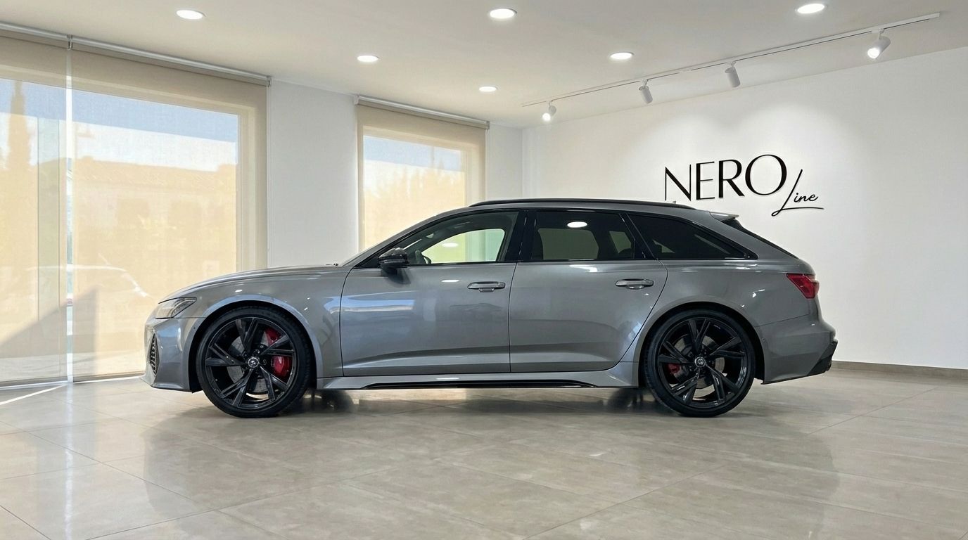 The metallic gray 2025 Audi RS6 Performance is showcased in a showroom, viewed from its elegant side profile in Marbella.