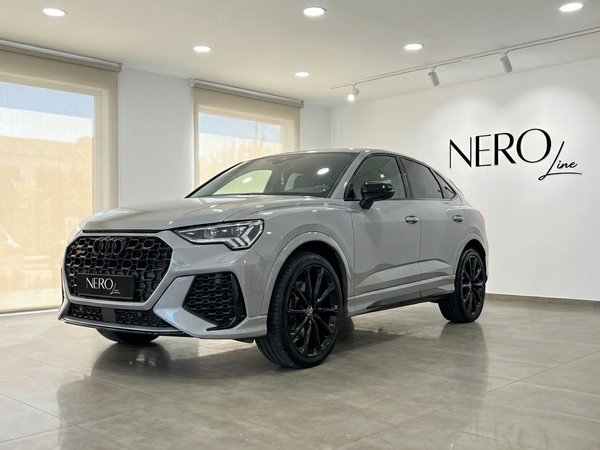 Audi RSQ3 — Luxury Performance SUV in Barcelona The metallic silver 2023 Audi RSQ3 is showcased from a front three-quarter angle indoors in Barcelona.