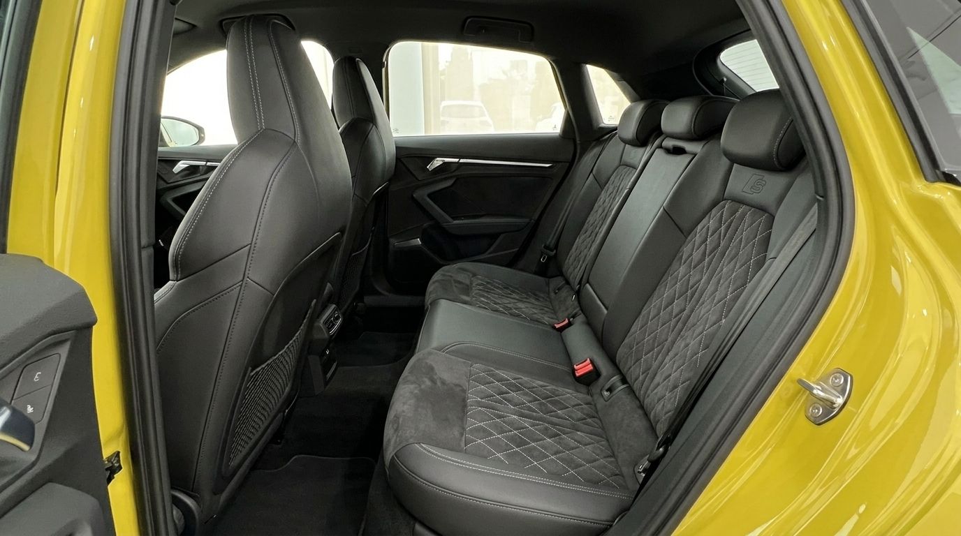 The luxurious rear interior of the Audi S3 in Alicante, featuring black leather seats with elegant diamond stitching.