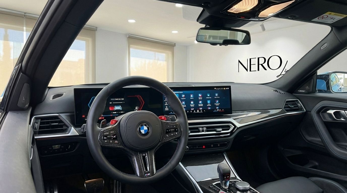 The luxurious cockpit and dashboard of the 2025 BMW M2 Competition, featuring a digital display and carbon fiber trim, available for rent in Alicante.