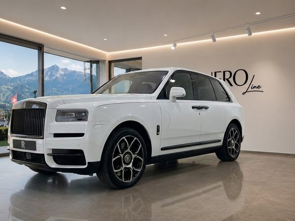 Rolls Royce Cullinan — Showroom in Zurich The white Rolls Royce Cullinan luxury SUV is displayed in a showroom with a panoramic view of the Swiss Alps near Zurich.