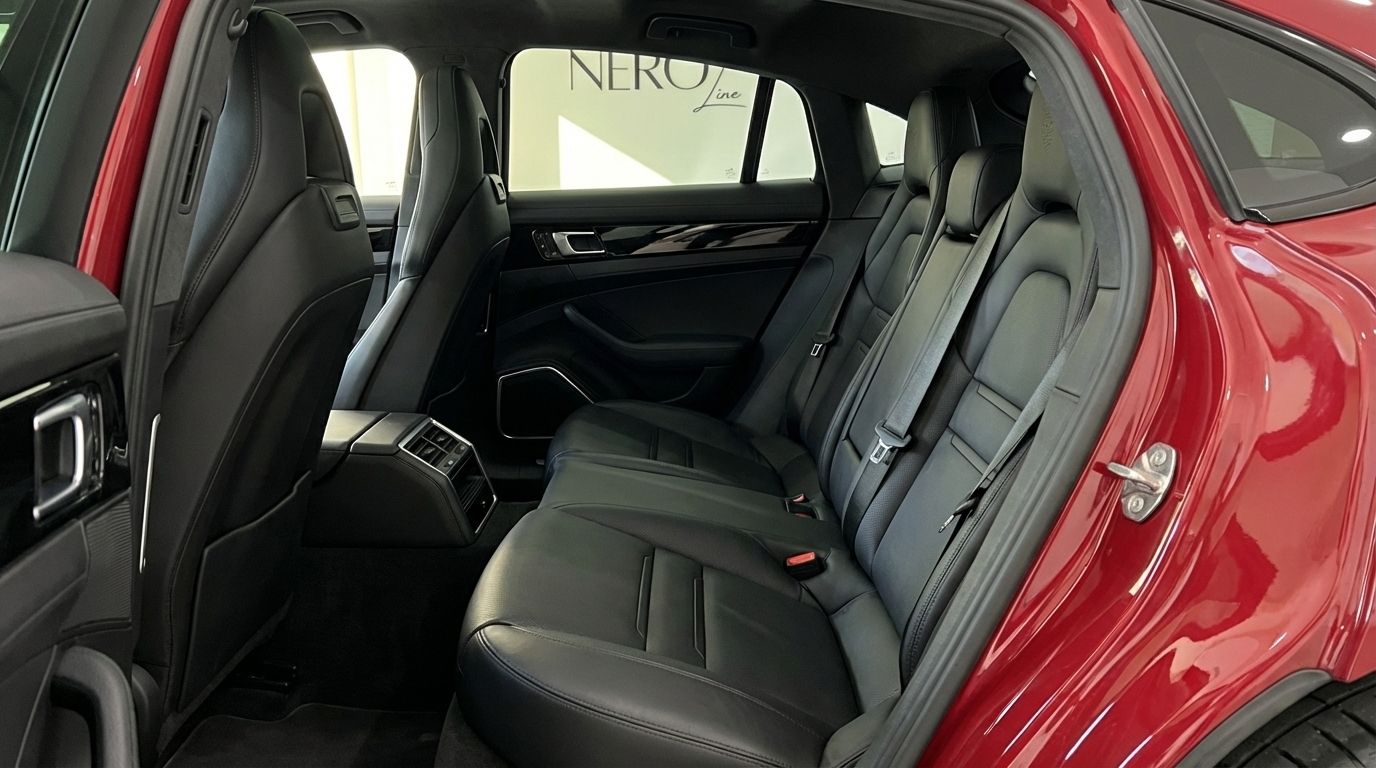 The black leather rear seats and door panel of the red Porsche Panamera 4S Hybrid in Alicante.