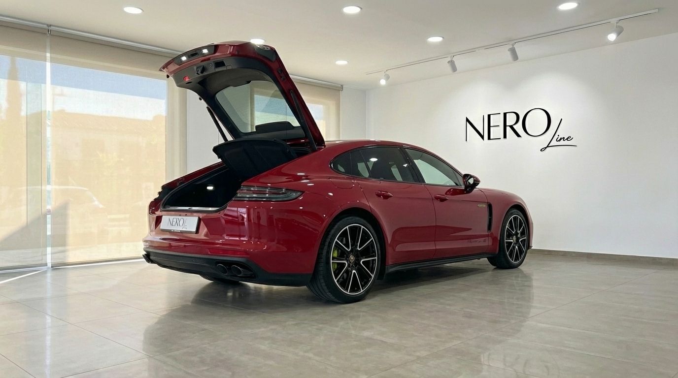 The racing red Porsche Panamera 4S Hybrid is shown from the rear three-quarter angle with its trunk open in Alicante.