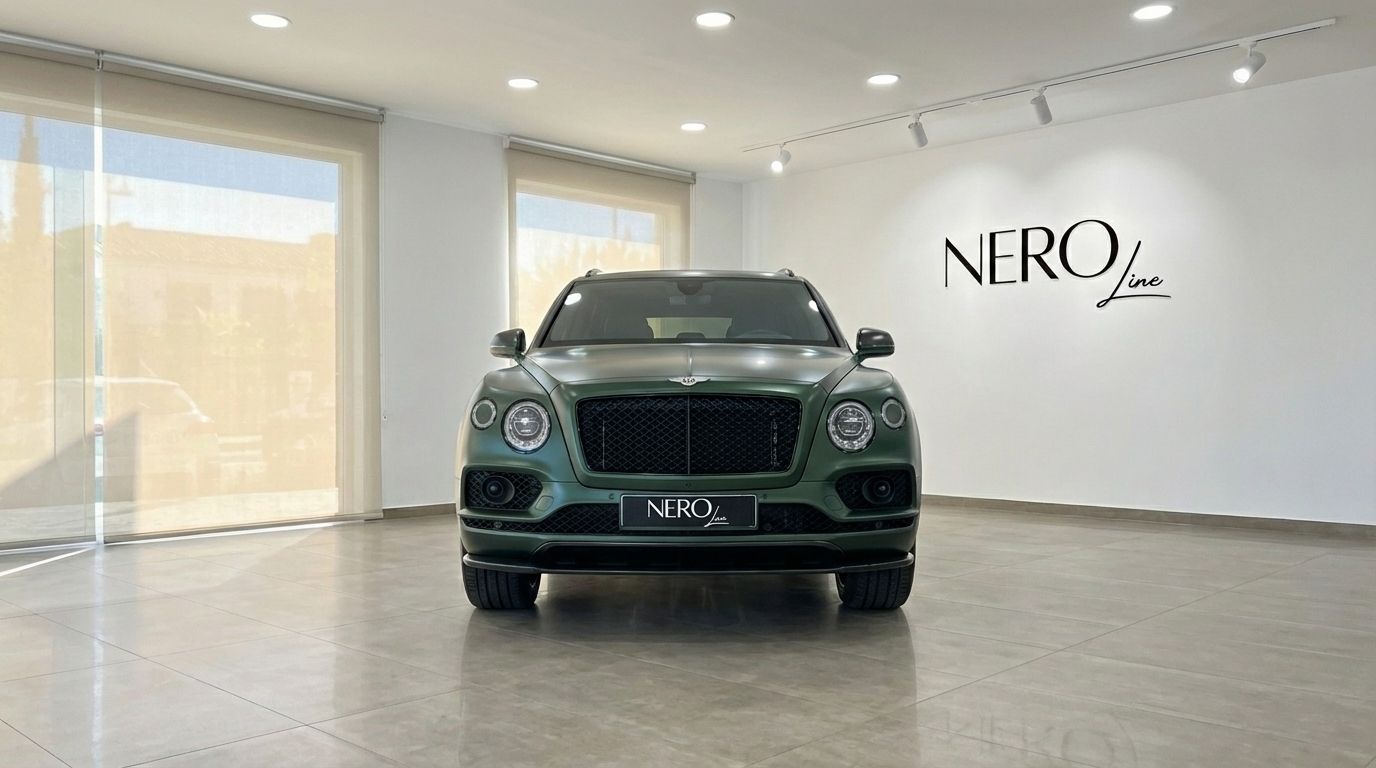The front view of a 2019 Bentley Bentayga in Satin British Racing Green, parked in a modern showroom in Valencia.