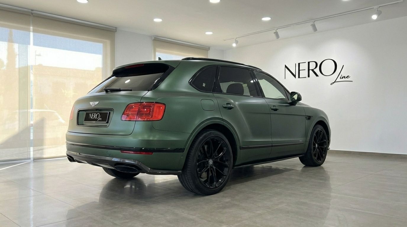 The 2019 Bentley Bentayga in Satin British Racing Green, showcasing its elegant rear three-quarter profile in Valencia.