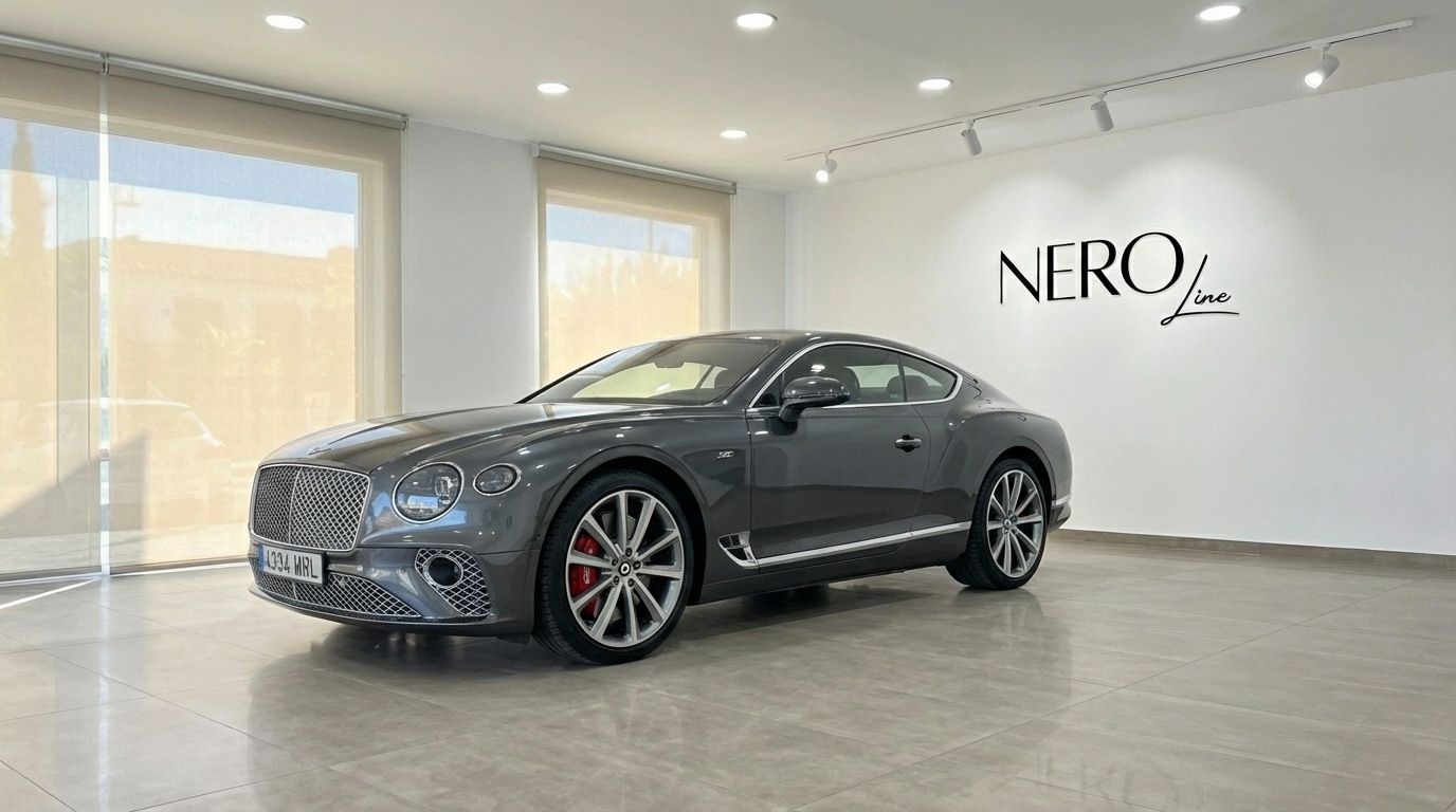 The gunmetal gray Bentley Continental GT Speed V12 is showcased from the front three-quarter view in a showroom in Alicante.