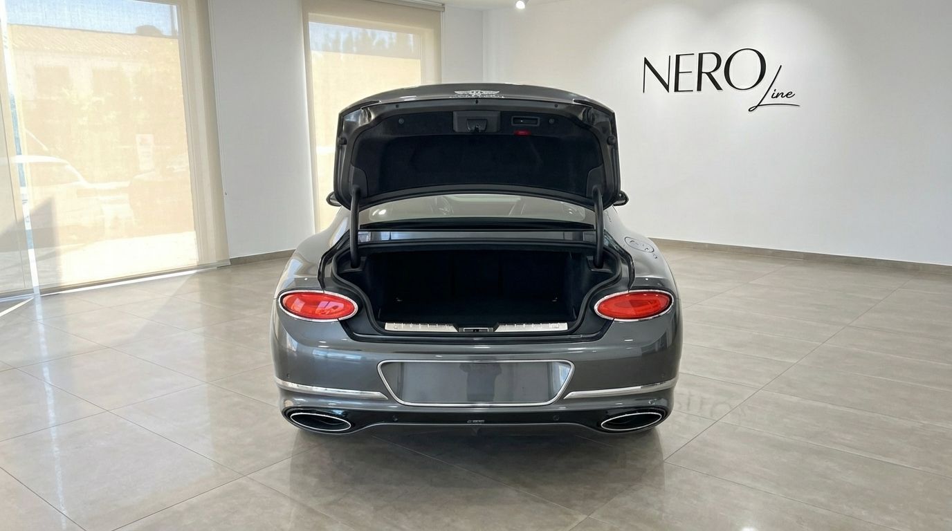 The gunmetal gray Bentley Continental GT Speed V12 is seen from the rear with its trunk open in Alicante.
