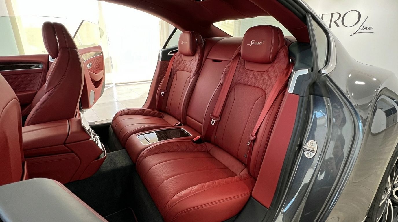 View of the Bentley Continental GT Speed V12's luxurious red leather rear seats with diamond stitching in Alicante.