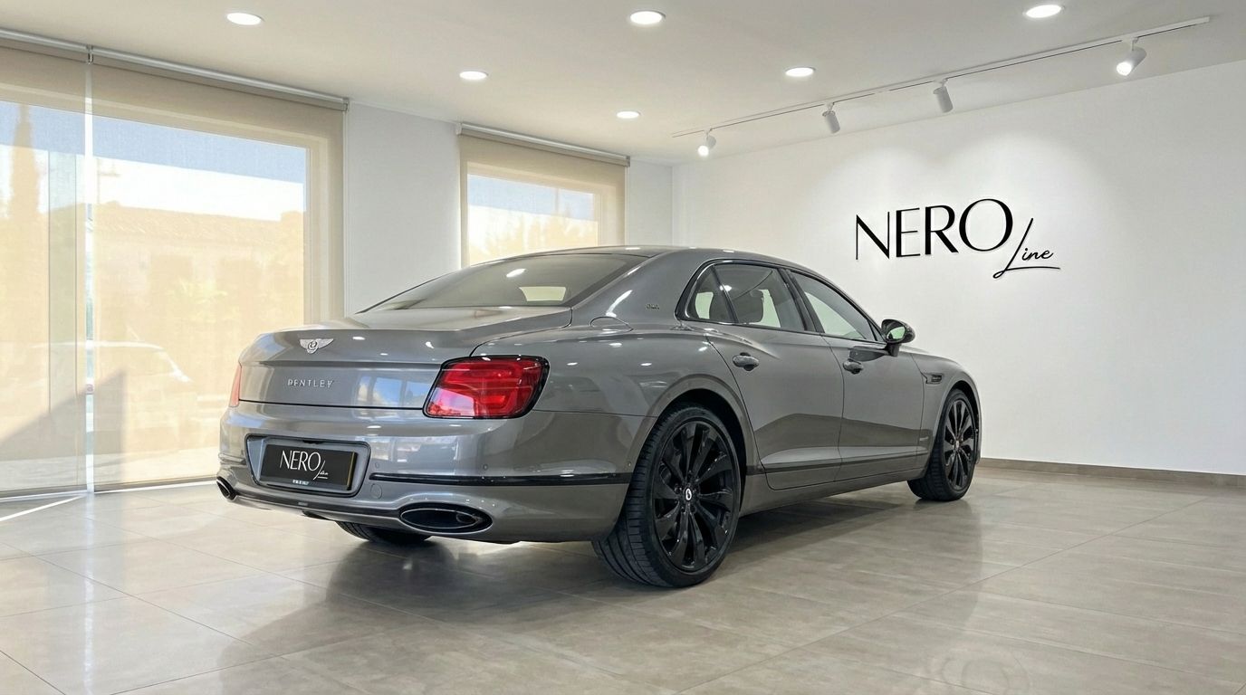 The metallic gray Bentley Flying Spur Special is shown from a rear three-quarter angle in a showroom in Marbella.