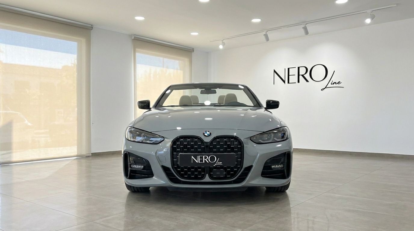 The metallic Brooklyn Grey BMW 420d Cabriolet is shown from a front view, parked indoors at NeroLine in Marbella.