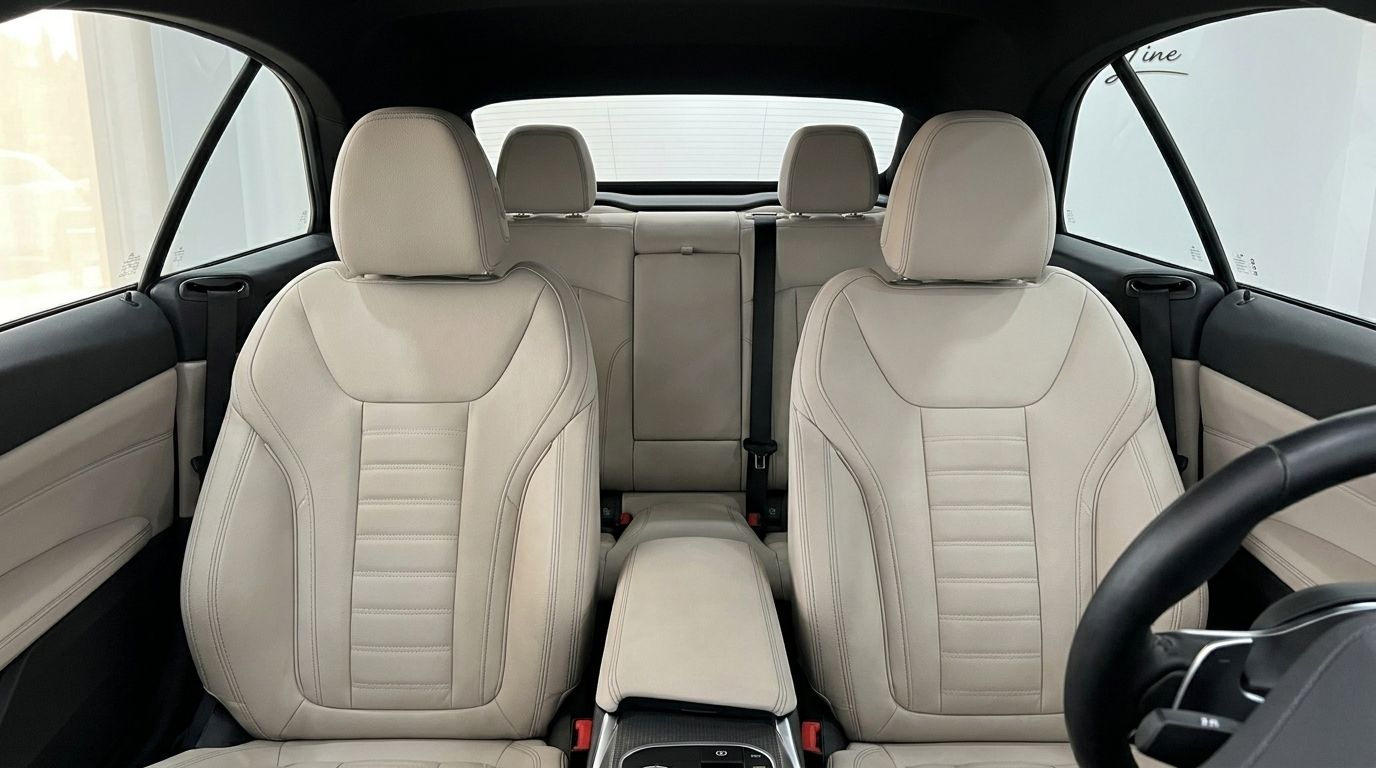 View of the luxurious light-colored front and rear seats inside the BMW 420d Cabriolet in Marbella.