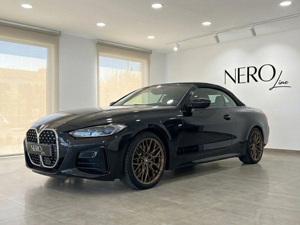 BMW 430i M Convertible — Showroom view Benidorm The gloss black 2023 BMW 430i M Convertible is showcased from a front three-quarter angle in a Benidorm showroom.