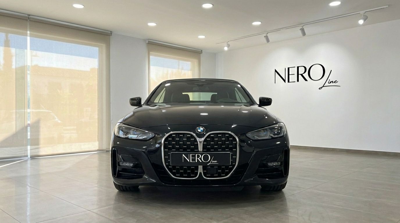 The 2023 BMW 430i M Convertible in gloss black is showcased from the front view in a Benidorm showroom.