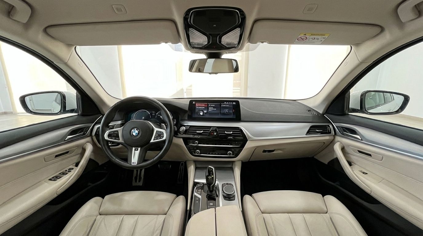 The luxurious interior of the BMW 530e xDrive, showcasing the dashboard, steering wheel, and front seats in Alicante.