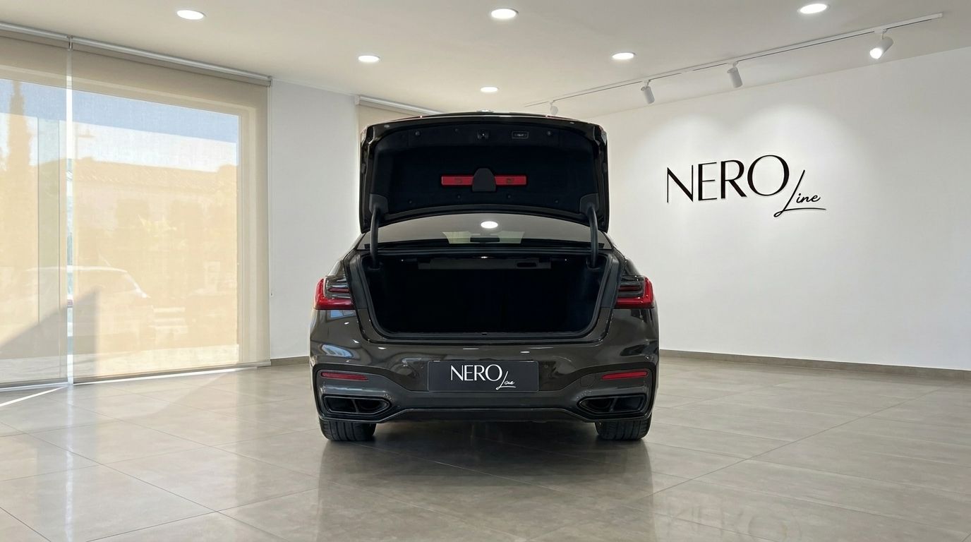 The BMW 730 luxury sedan is presented from the rear with its trunk open, showcasing the ample cargo space in Alicante.