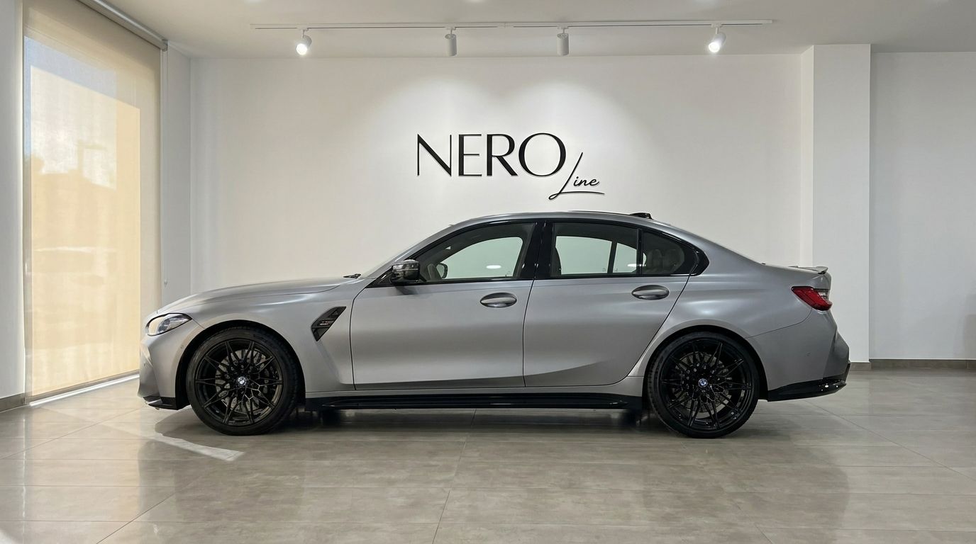 The 2023 BMW M3 Competition xDrive in Matte Frozen Pure Grey, shown from the side in a showroom in Marbella.