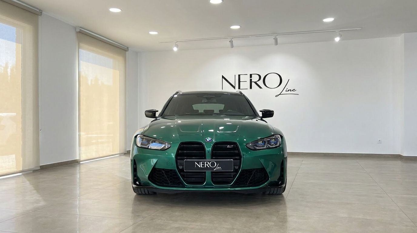 Front view of the metallic Isle of Man Green BMW M3 Touring Competition xDrive in a showroom in Marbella.