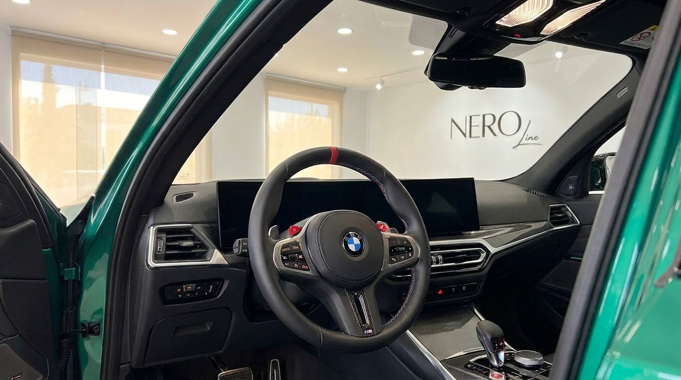 The driver's cockpit of the BMW M3 Touring Competition xDrive in Marbella, featuring the steering wheel and dashboard.