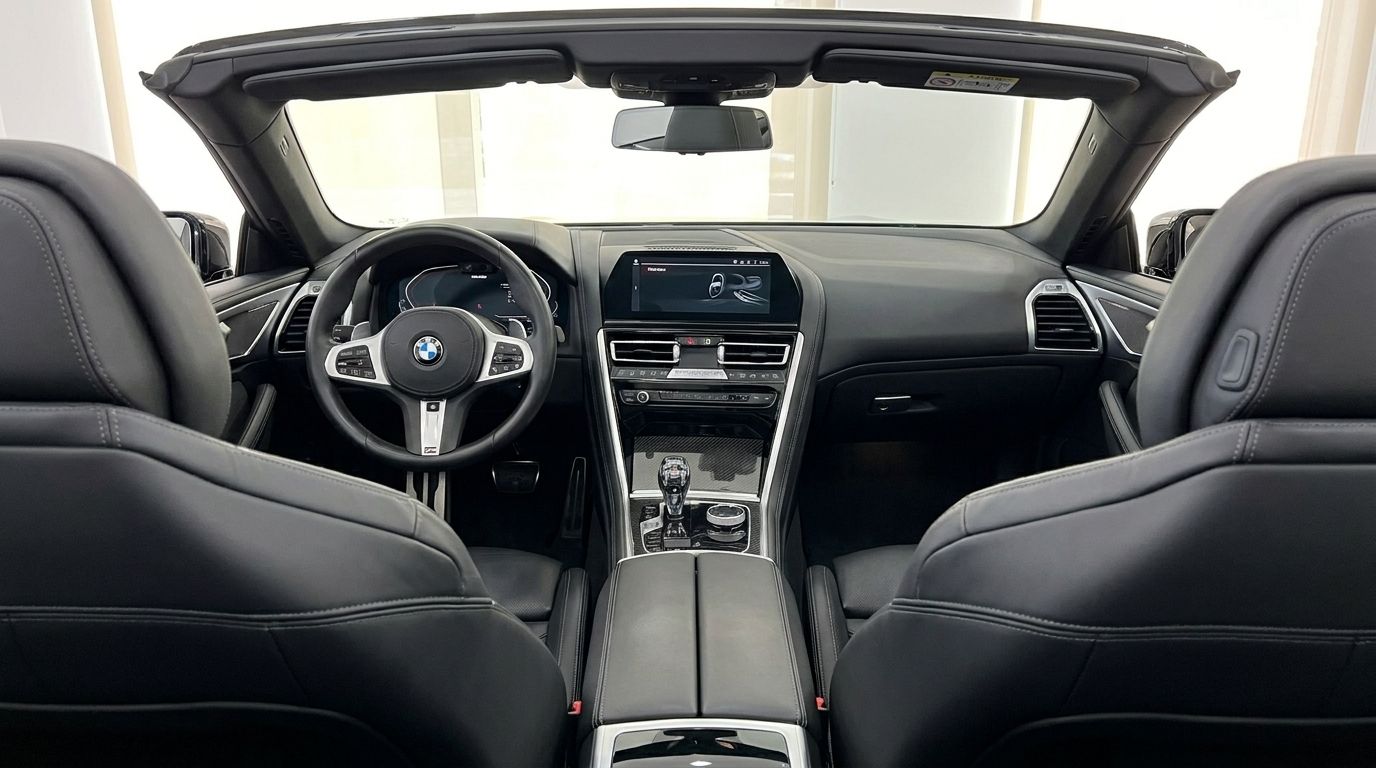 The luxurious black leather interior of the BMW M850, featuring the dashboard, steering wheel, and front seats, visible in Alicante.