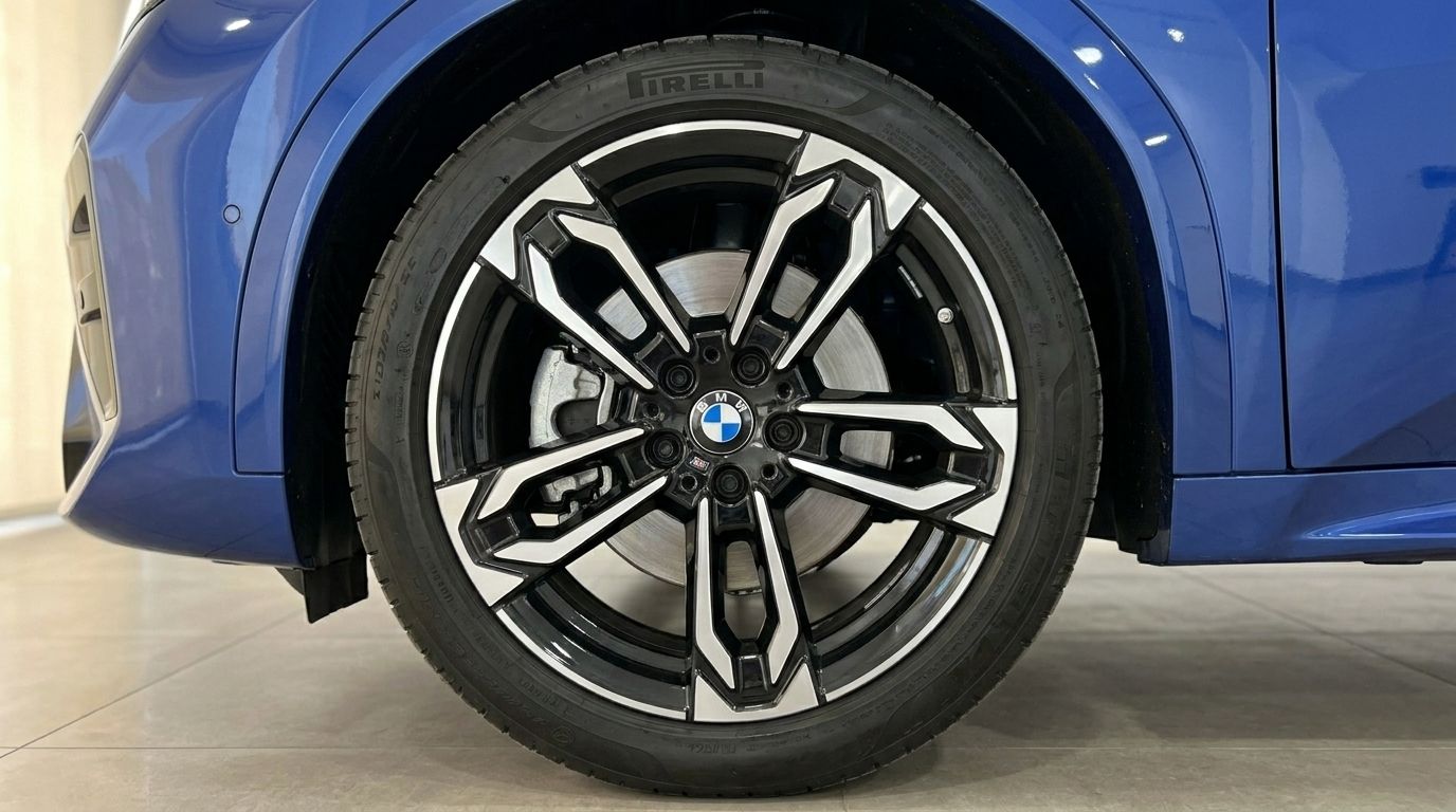 The front alloy wheel with a black and silver multi-spoke design on the blue BMW X2 in Alicante.