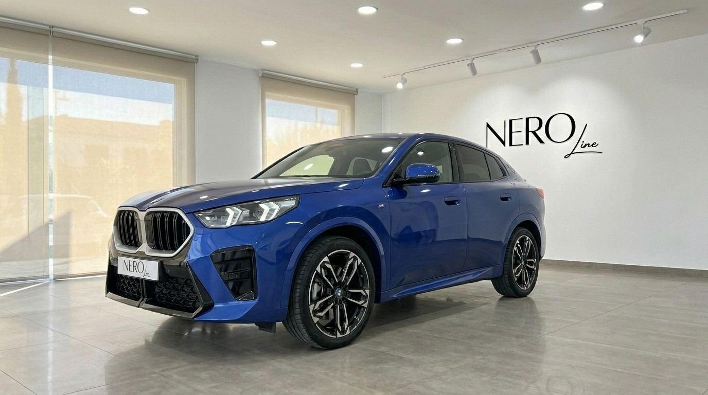 BMW X2 — Luxury Car Rental in Alicante The blue 2025 BMW X2 is prominently displayed in a showroom, captured from a front three-quarter angle in Alicante.