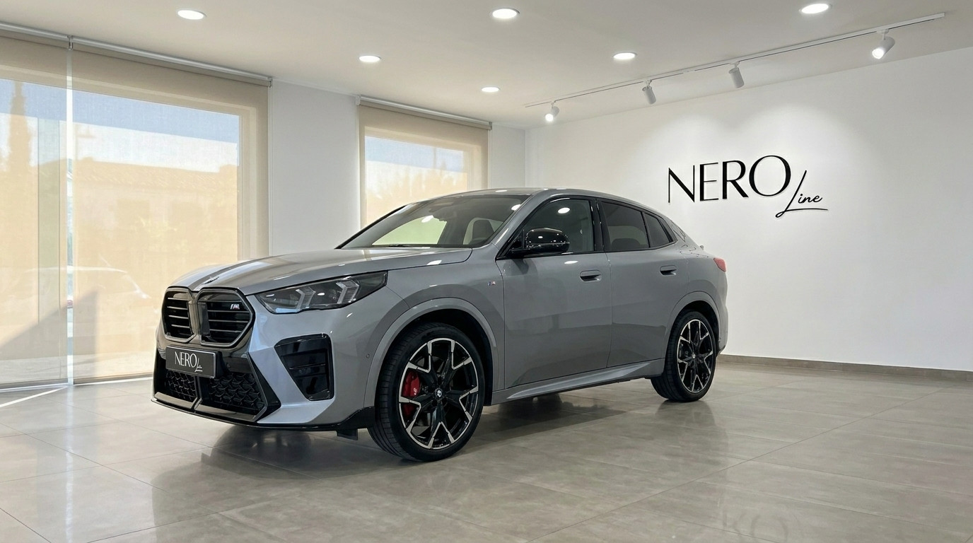 BMW X2 M35i xDrive — Front three-quarter view The 2024 BMW X2 M35i xDrive in gloss metallic grey is showcased from a front three-quarter angle in a Marbella showroom.