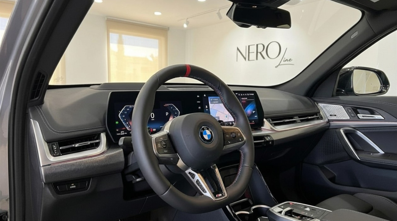 The luxurious interior cockpit of the 2024 BMW X2 M35i xDrive in Marbella, featuring the steering wheel and digital displays.