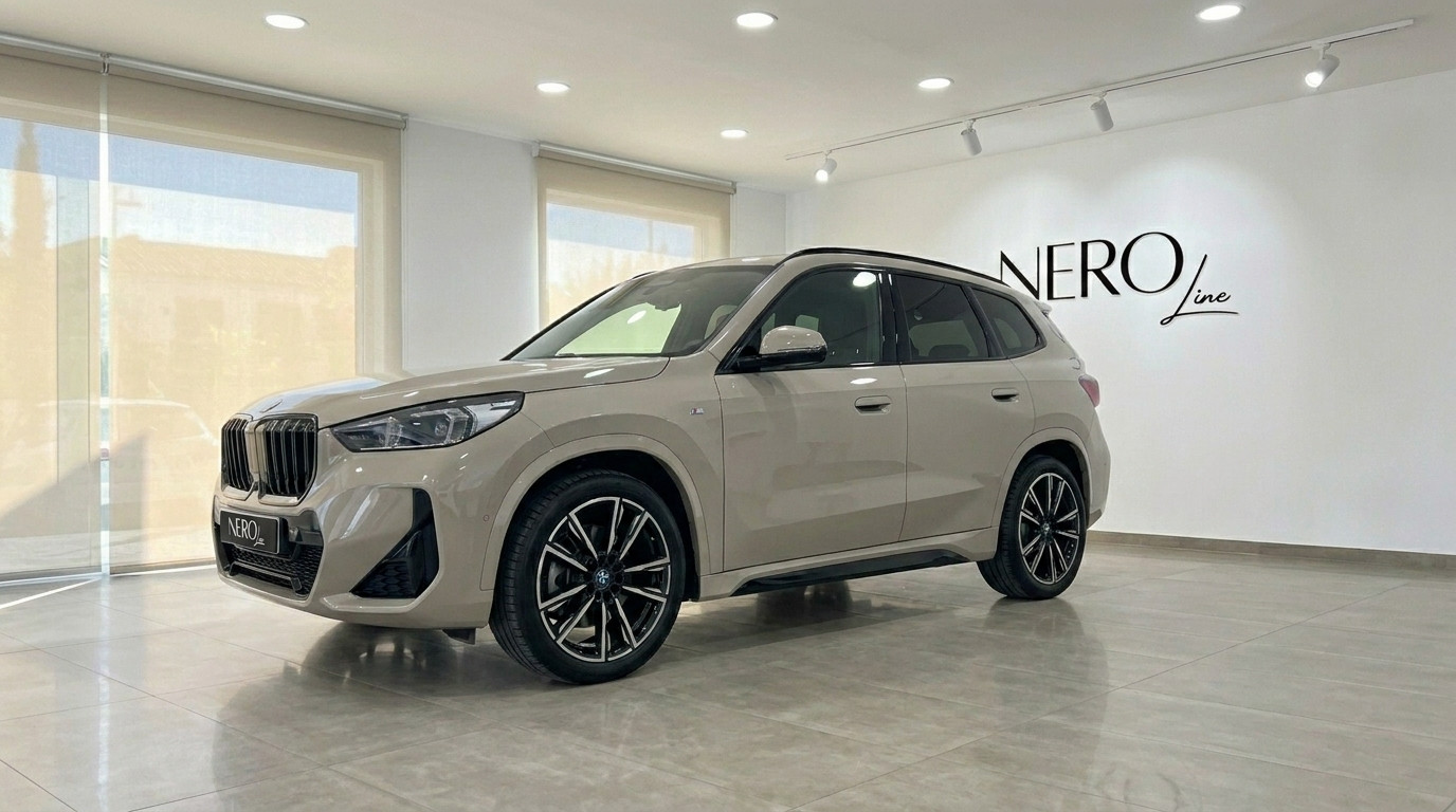 BMW X3 2.0 Diesel — Front three-quarter view The gloss beige BMW X3 2.0 Diesel is showcased from a front three-quarter angle inside a modern showroom in Alicante.