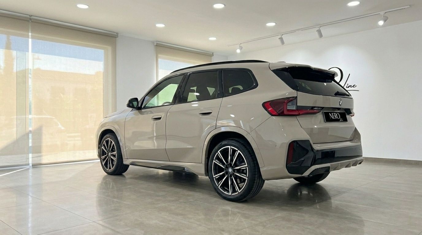 The gloss beige 2026 BMW X3 2.0 Diesel is showcased from a rear three-quarter angle in a showroom in Alicante.