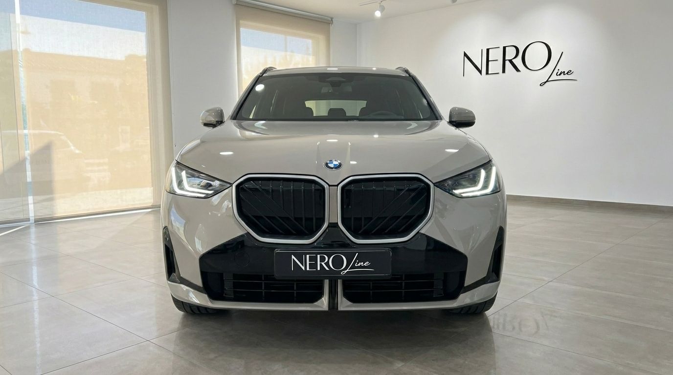 The front view of the gloss beige 2026 BMW X3 2.0 Diesel, showcasing its grille and headlights in a showroom in Alicante.
